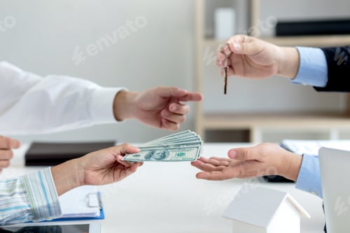 Preview: Estate agent giving house key for client.