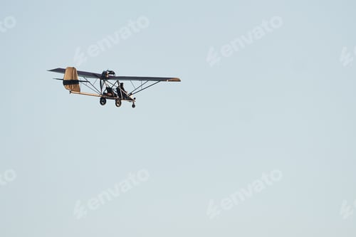 Preview: Plane flying high up in the cloudless sky at daytime. Male pilot