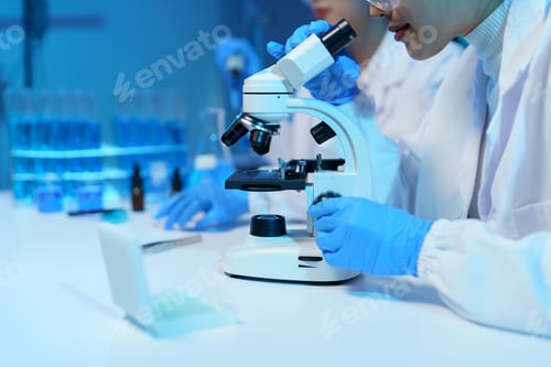 Preview: Close-up of scientist's hands adjusting microscope, conducting research in a modern laboratory with