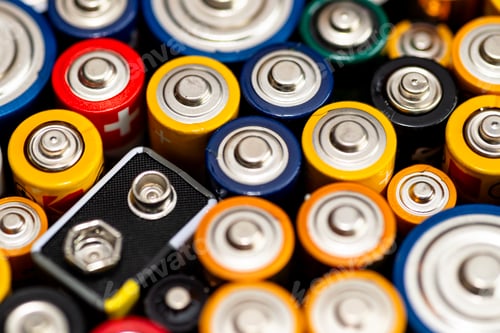 Preview: Background made of various alkaline and lithium-ion batteries, positive pole visible.