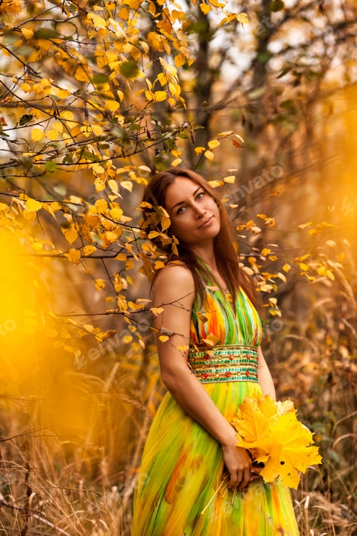 Preview: Captivating Woman Embraces the Golden Essence of Autumn at a Park in October