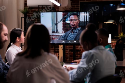 Preview: Diverse team working overtime discussing with remote manager during online video call conference