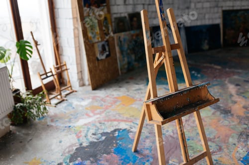 Preview: Close up photo of classic wood easel in modern art workshop with