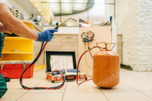 Preview: Male person hands with burner repairs refrigerator