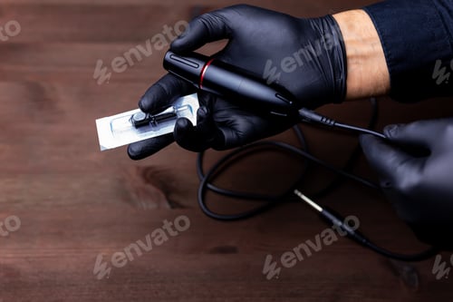 Preview: the hands of the permanent makeup master in black medical gloves