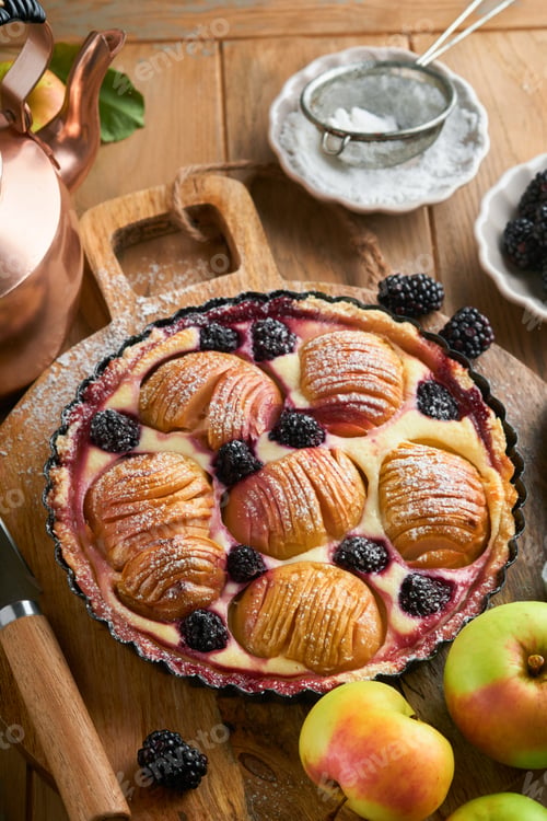 Preview: Apple pie. Apple and blackberries cake or pie decorated sugar powder on old wooden table. Delicious