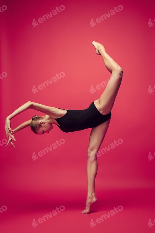 Preview: Young teen dancer on red studio background.