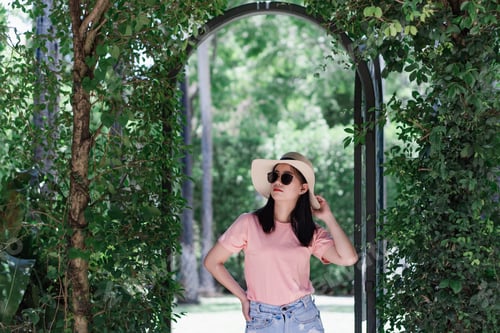 Preview: Woman Poses Under a Lush Garden Archway