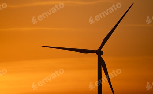 Preview: Wind turbine silhouette against sunset sky. Wind power. Sustainable renewable energy generation.