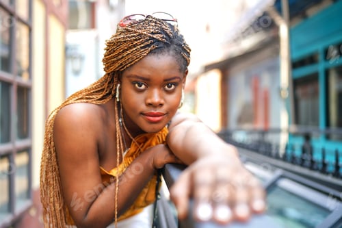 Preview: Stylish Woman with Braids Leans on Railing