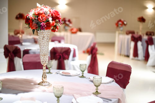 Preview: Banquet tables with festive serving of dishes, decoration with bouquets