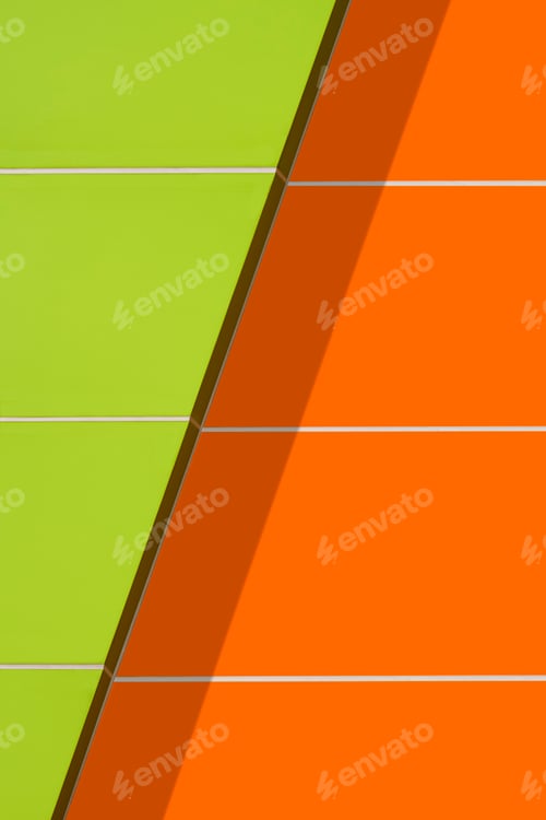 Preview: Sunlight on vibrant green and orange aluminum composite tiles exterior wall of modern building