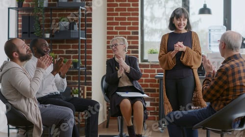 Preview: Happy adult celebrating recovery success with group of people clapping hands at aa meeting