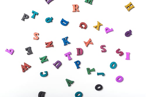 Preview: Scattered colored letters on a white background. Reading or education concept.