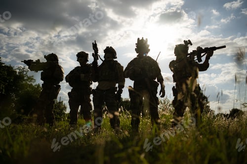 Preview: Soldier holding gun and showing action success or war win, special forces military training concept.