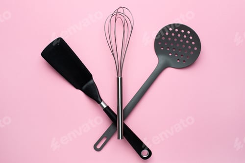 Preview: Kitchen accessories spatula whisk on a pink background, female cooking