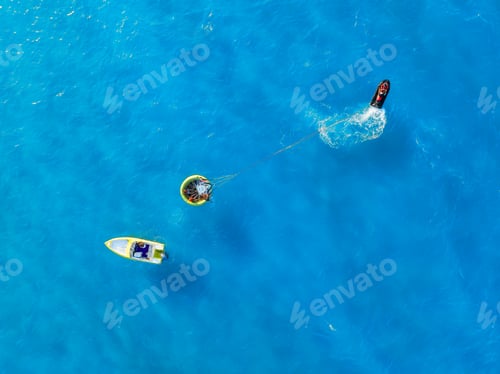 Preview: Vacation and leisure. Aerial view on fast boat on blue sea at sunny day.