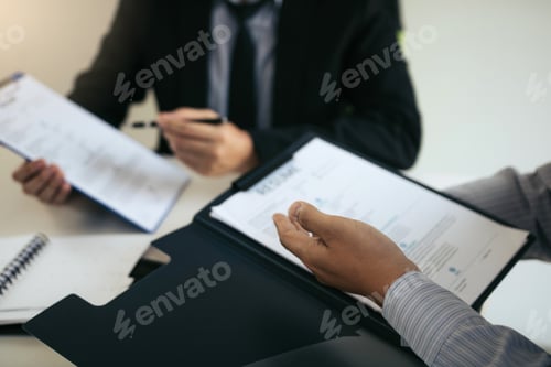 Preview: Employee is describing the work experience in the resume paper for the manager at the office.