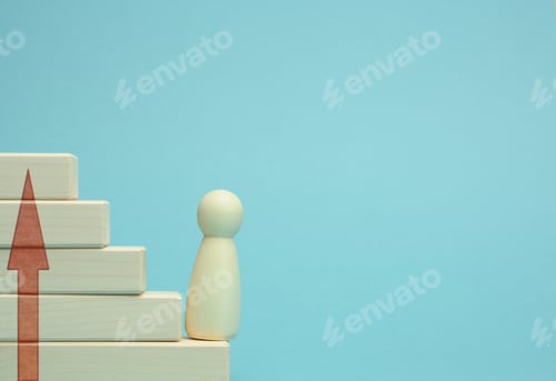 Preview: Wooden figurine of a man stands on a staircase made of blocks on the first step