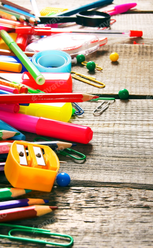 Preview: School tools. On wooden background.