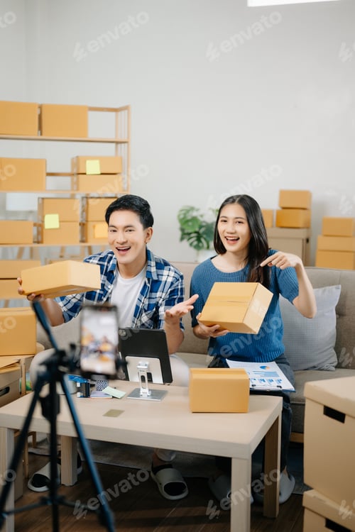 Preview: Two Asian blogger showing clothes in front of the camera to recording vlog video live