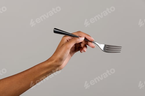 Preview: Black female hand showing fork