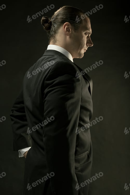 Preview: The Attractive Man In Black Suit On Dark Background