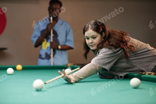 Preview: Young Woman Concentrating on Billiards Shot