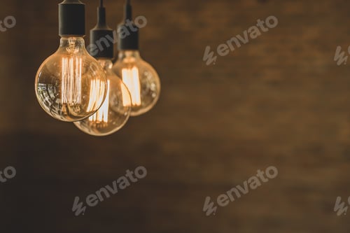 Preview: Three lightbulbs on a brown wall background with free space for text
