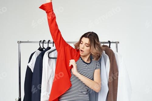 Preview: woman trying on a red shirt isolated background