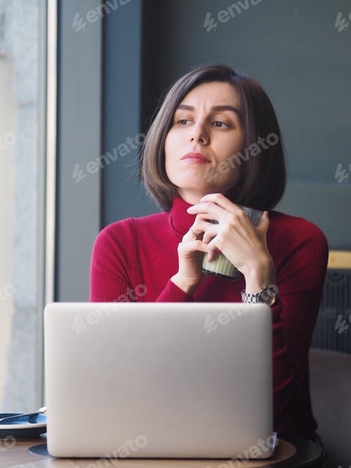 Preview: Portrait of confident and serious businesswoman with short dark hair looking out window, portrait.
