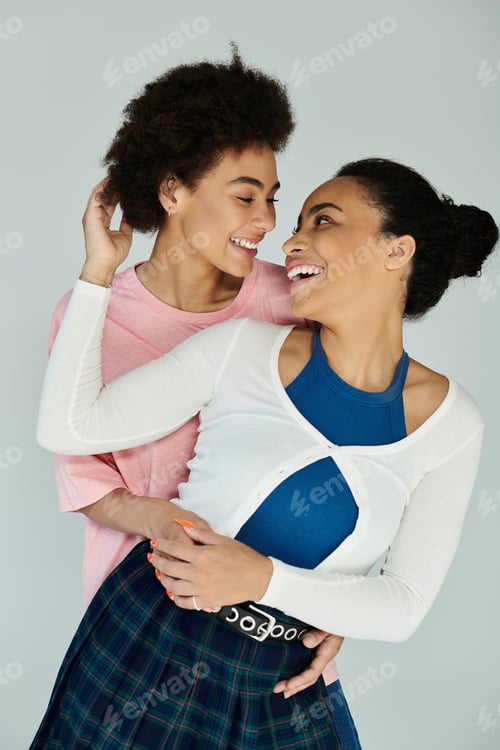 Preview: Joyful portrait of two friends sharing a warm embrace in a vibrant, creative studio setting