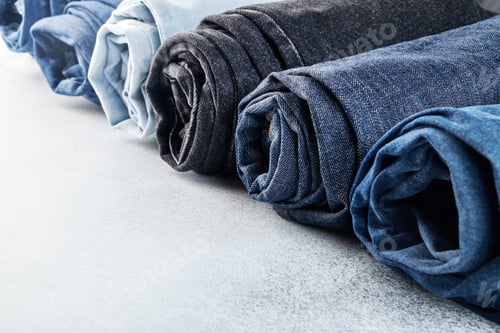 Preview: Row of different rolled jeans on white background