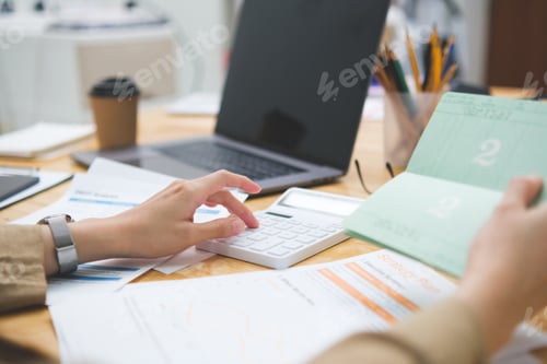 Preview: Accountant or businesswoman checks the contents of his savings book calculating finances.