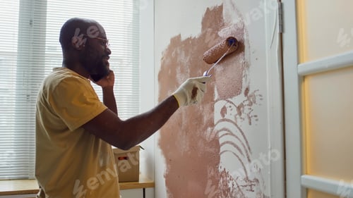 Preview: Painting Wall with Roller Wearing Protective Gloves