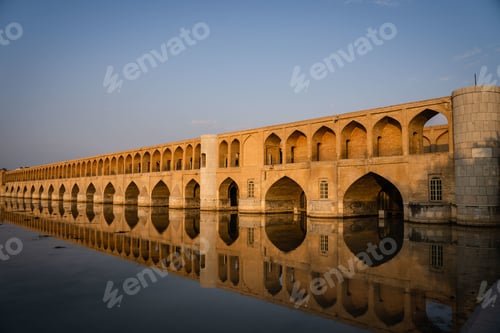 Preview: Allahverdi Khan Bridge reflecting on the water under a blue sky during daytime