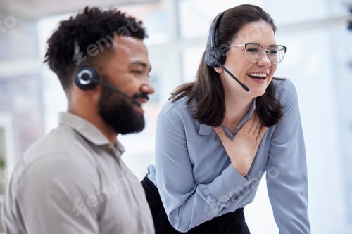 Preview: Cheerful caucasian call centre telemarketing agent training new mixed race assistant on in an offic