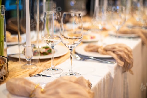 Preview: beautiful table setting with flowers and cutlery on wooden table at wedding or dinner. stylish table