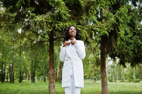 Preview: Portrait of stylish black african american girl stay on green park