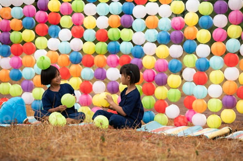Preview: Childhood life in rural Thailand. A small child plays with colorful little hanging lamp