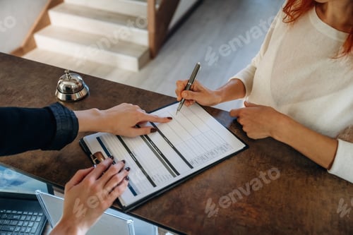 Preview: Registration process, document. Woman is at reception of the modern hotel