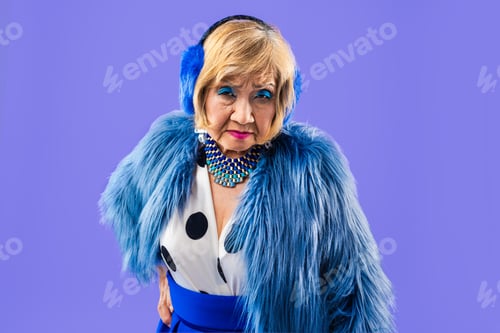 Preview: Happy and funny senior old woman on colorful background