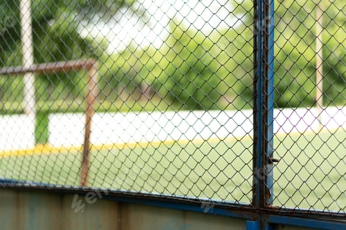 Preview: Rusty grating around the football field opposite the rusty gate