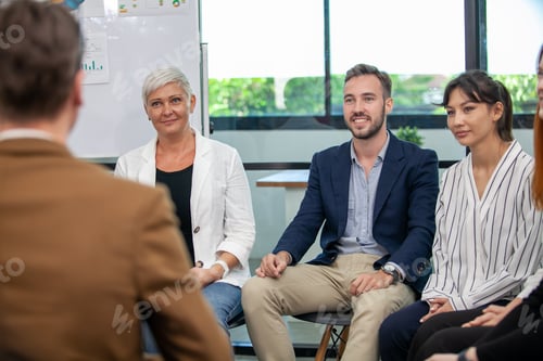 Preview: business team male and female colleagues talking at work share ideas with chart on board.
