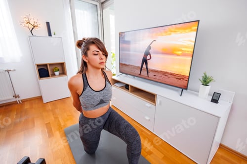 Preview: Woman stretching while doing online home workout