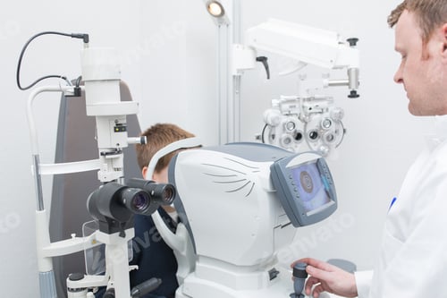 Preview: Optician testing a boy's eyes