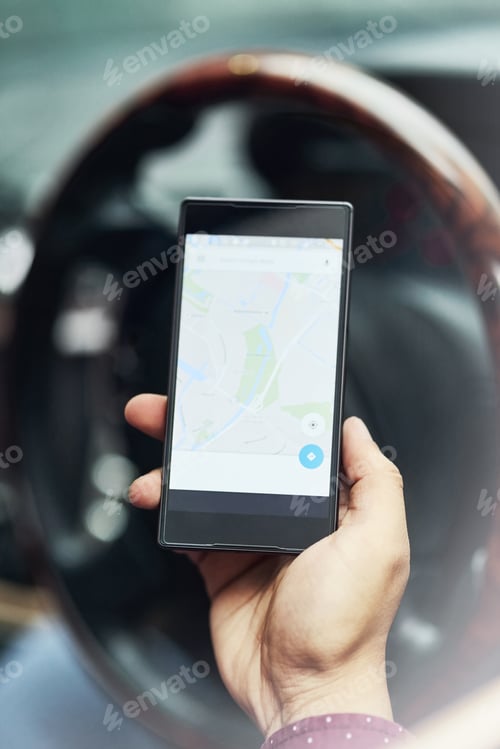 Preview: Know your place in the world. Closeup shot of a driver using his cellphone for directions.