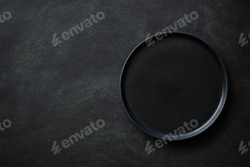 Preview: Empty Black Plate on Black Table.