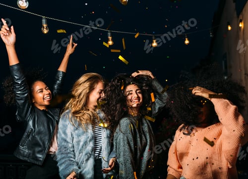 Preview: Group of young women having a party at night, dancing on a terrace