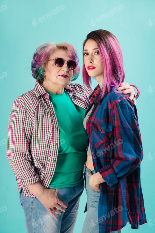 Preview: Young girl and happy senior woman in colorful casual clothes. Two generations of hipsters. Stylish s